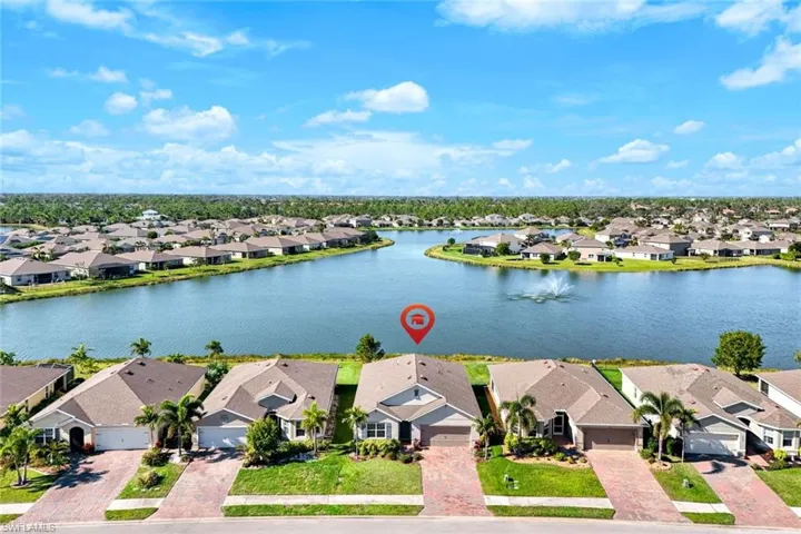 Birds eye view of property with a water view