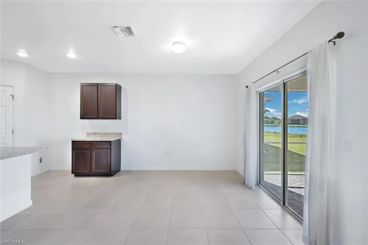 Kitchen with dark brown cabinets and light tile patterned floors
