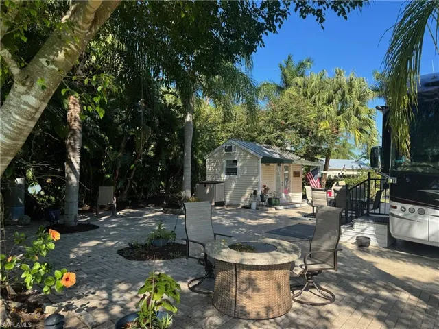 View of patio / terrace with an outdoor structure and an outdoor fire pit