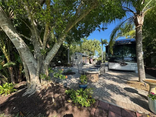 View of yard with a patio and an outdoor fire pit