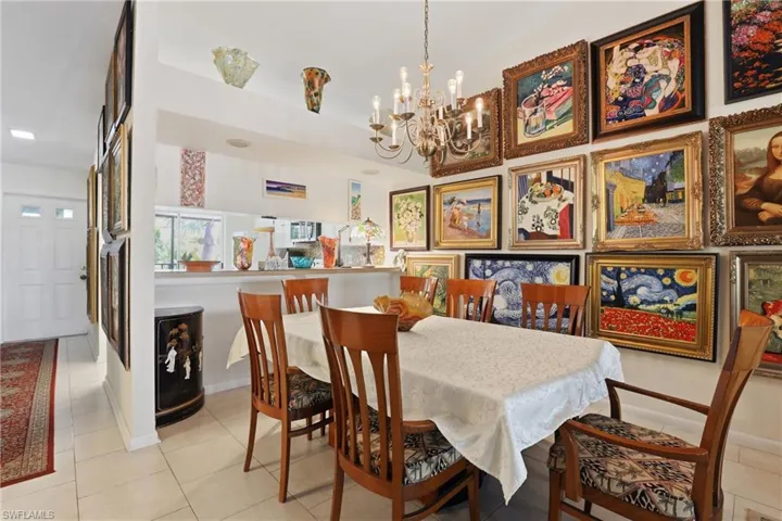 Dining area featuring a classic chandelier and tile flooring