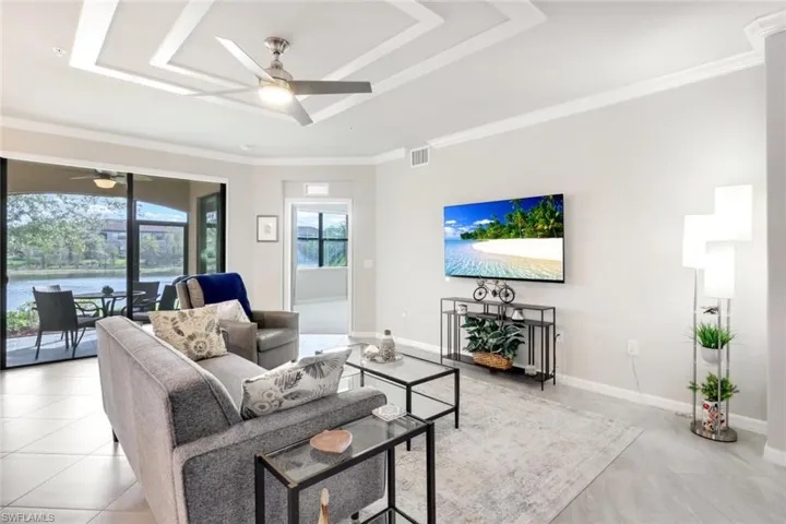 Living area with decorative ceiling and lake view