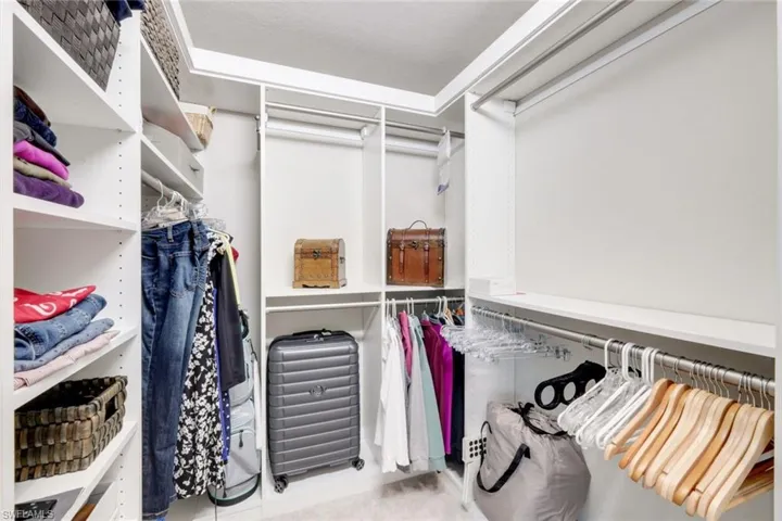 Primary bedroom with two custom closets.