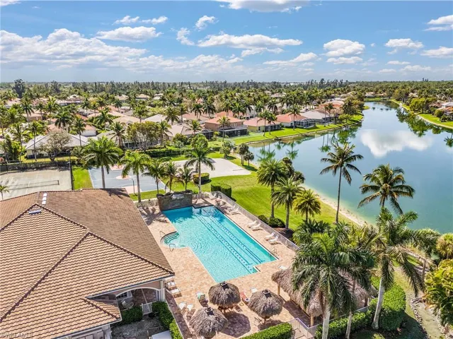 Aerial of community pool and sandy beach area.