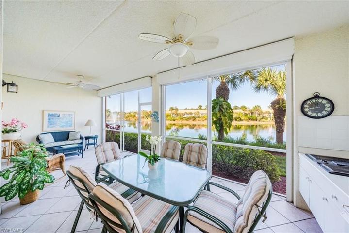 The lanai features a beautiful lake view, outdoor kitchen, tiled floor and electric storm shutters