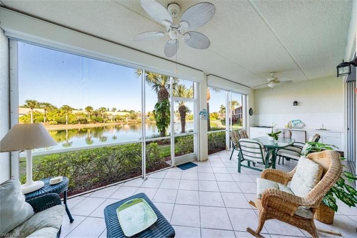 The extra large lanai features a beautiful lake view, outdoor kitchen, tiled floor and electric storm shutters