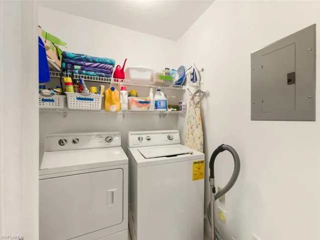 Washroom featuring electric panel and separate washer and dryer