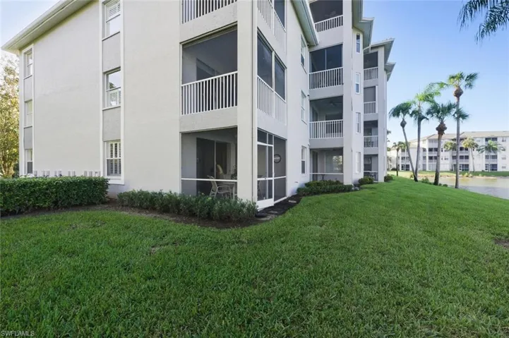 View of apartment building / complex featuring a water view