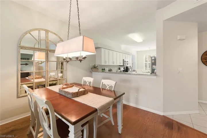 Dining space featuring light wood finished floors and a chandelier