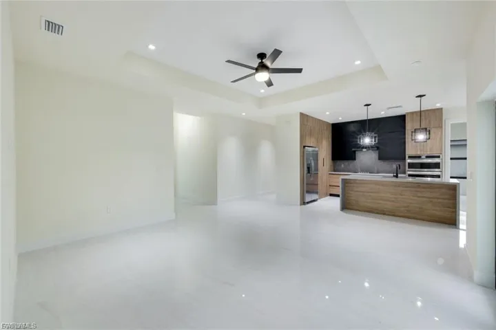 This inviting living room offers a clear view toward the front entrance and the hallway that leads to the guest rooms, providing an open and functional layout that enhances the home's flow.