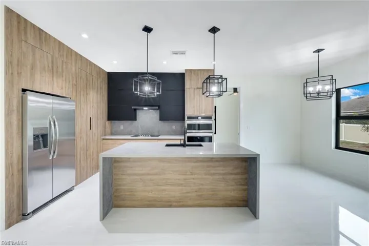 This well-appointed kitchen offers ample counter space, sleek cabinetry, and modern appliances, perfect for both everyday meals and entertaining. Its open layout connects effortlessly to the living areas, making it ideal for cooking and socializing.