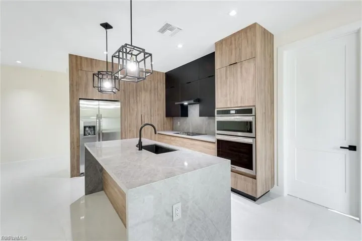 This kitchen is designed with entertaining in mind, offering ample counter space and an open layout that allows you to engage with guests while preparing meals, making it ideal for gatherings.