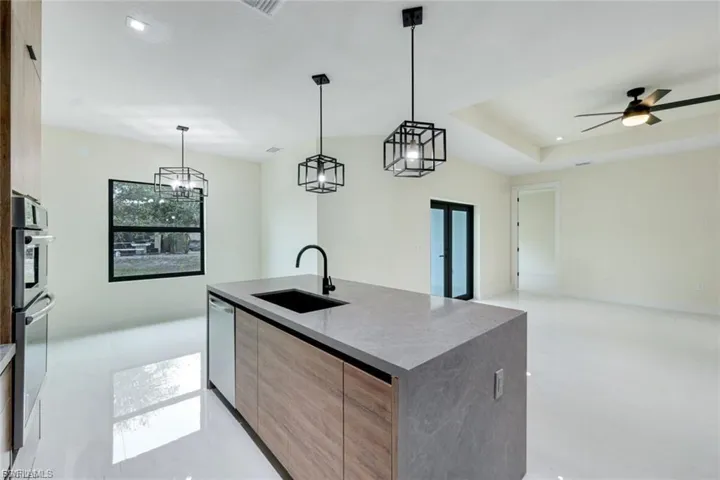 This kitchen is enhanced by ample natural light and stylish fixtures, creating a bright and inviting atmosphere.