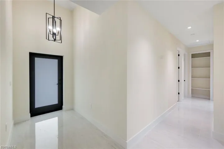 Enter into a warm, inviting space with beautiful flooring and soft lighting, offering a seamless flow into the rest of the home.