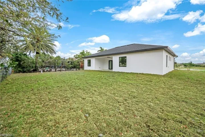This private backyard offers a serene space for relaxation and entertaining, with ample room for outdoor dining, play, or simply enjoying the natural surroundings in peace.
