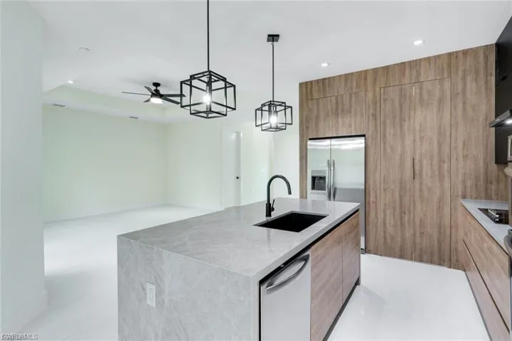 This kitchen features a generously sized pantry, offering plenty of storage space for all your essentials, keeping the kitchen organized and clutter-free.