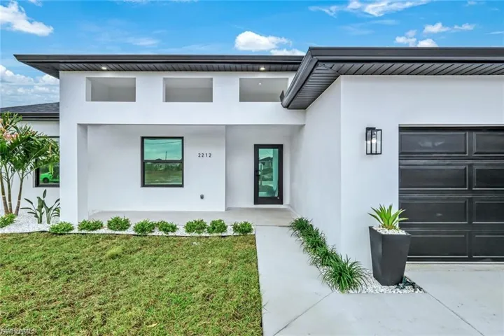 The front entrance features sturdy impact windows and doors, offering both style and security while allowing natural light to fill the space. A perfect blend of protection and curb appeal.