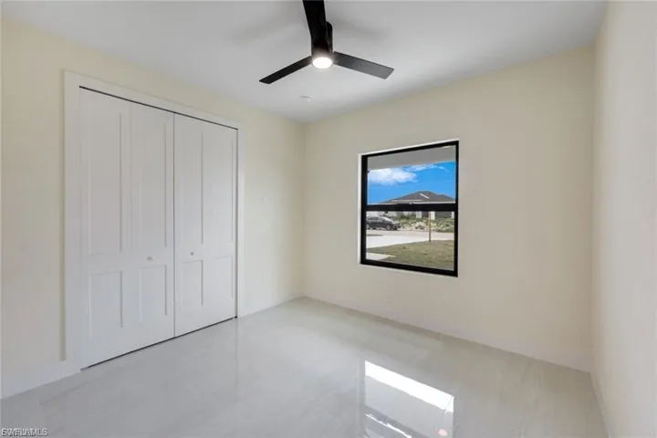 Guest bedroom features custom closets with drawers.
