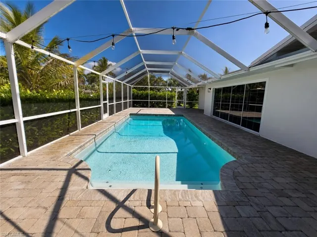 Screened-in swimming pool with a rectangular shape and integrated steps