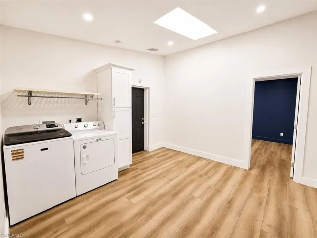 Recessed lighting, skylight, wood-finish flooring, built-in cabinetry, and integrated shelving
