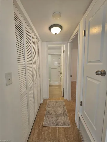 Hallway featuring tile patterned floors