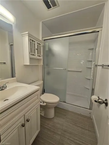 Bathroom featuring vanity and a stall shower