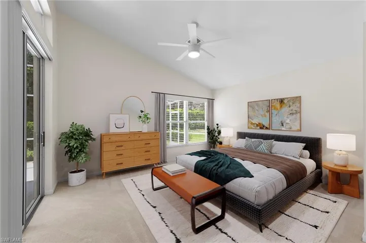 Bedroom with lofted ceiling, carpet flooring, a ceiling fan, and access to exterior