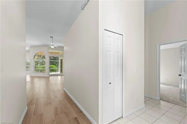 Corridor featuring baseboards and light wood finished floors