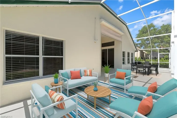 Virtually staged patio terrace featuring a sunroom, an outdoor living space, glass enclosure, and outdoor dining area