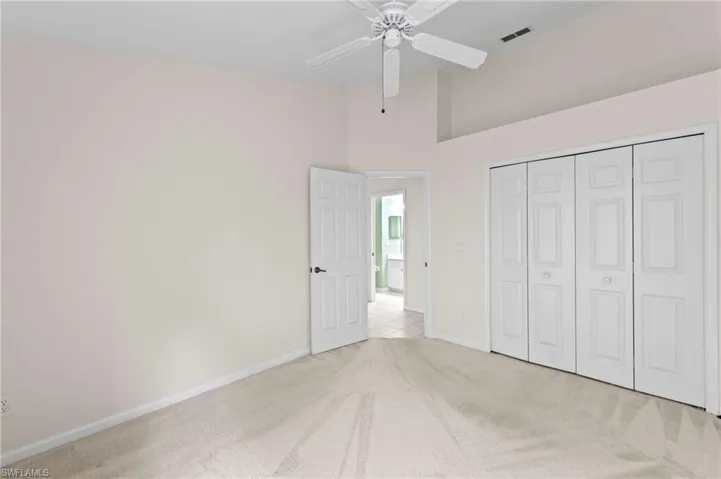 Unfurnished bedroom with carpet floors, a ceiling fan, and a closet