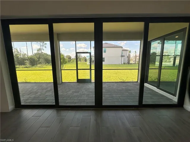 Doorway to outside featuring dark hardwood / wood-style floors