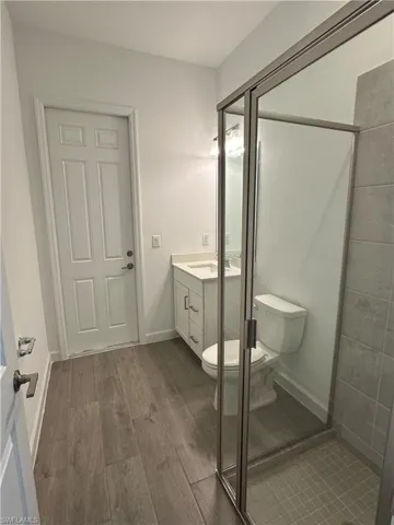 Bathroom featuring vanity, toilet, and hardwood / wood-style flooring