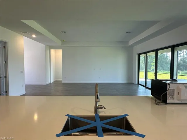 Kitchen featuring hardwood / wood-style flooring and a raised ceiling