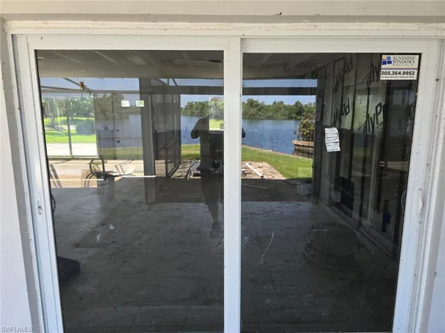 Doorway to outside with a water view and healthy amount of natural light