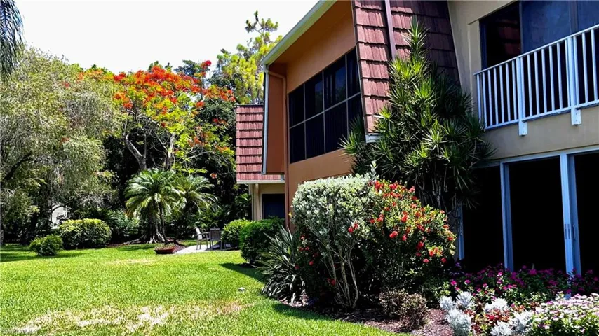 View of side of home with a yard