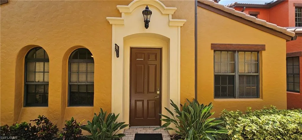 Property entrance with stucco siding and a tiled roof