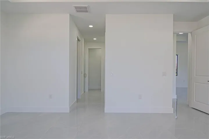 Empty room featuring visible vents, recessed lighting, and baseboards