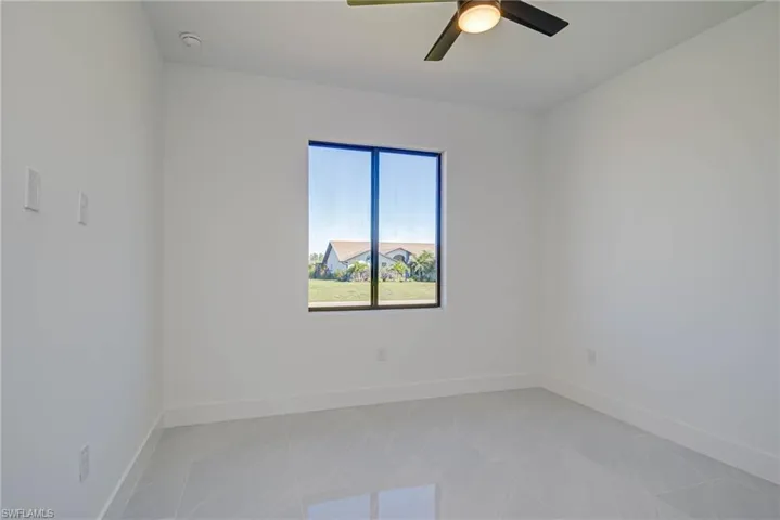 Spare room with a ceiling fan and baseboards