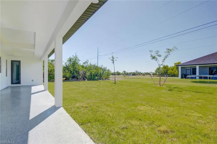 View of yard with a patio and a trampoline