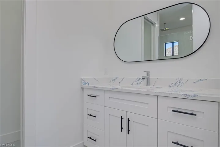Bathroom with recessed lighting and vanity