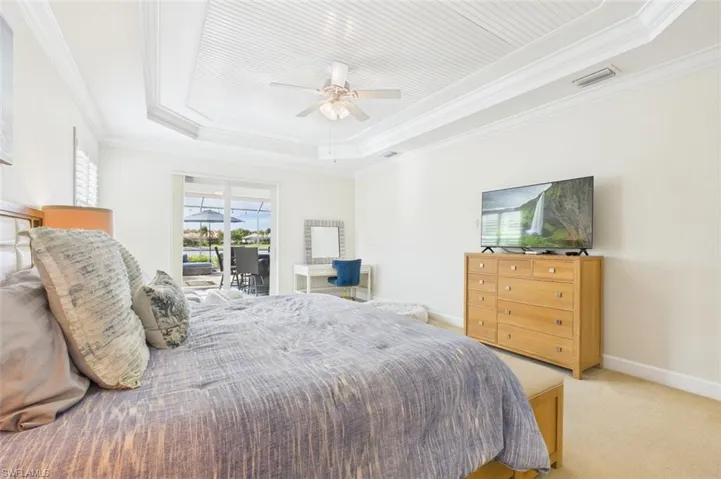 primary bedroom vanity and sliding glass doors leading out to the lanai