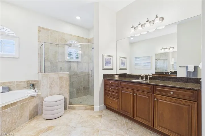 primary bath glass enclosed shower and soaking tub