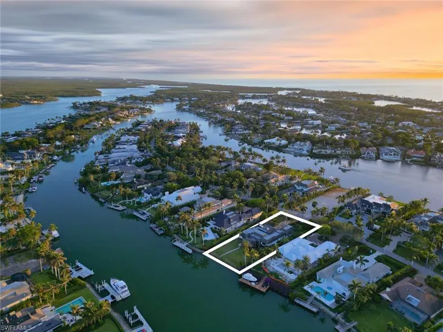Aerial view at dusk featuring a water view