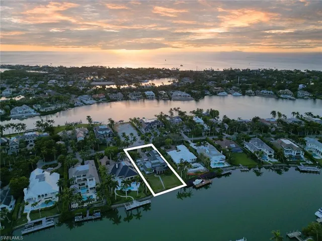 Aerial view at dusk featuring a water view