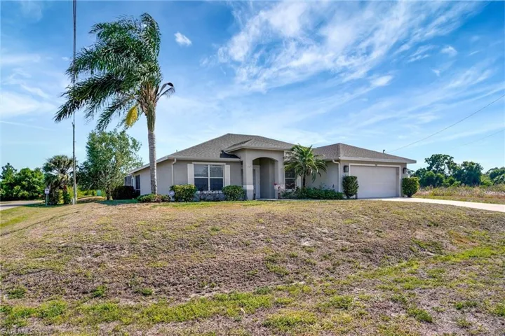 Single story home with a garage, driveway, and stucco siding