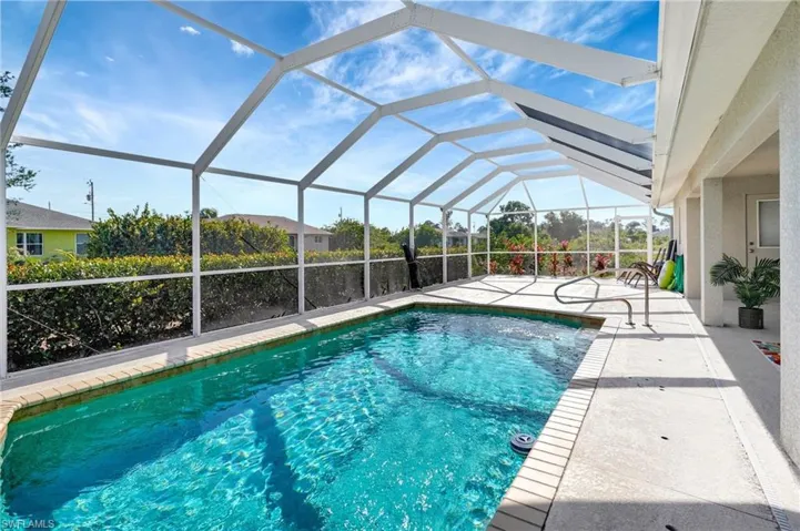 Pool with a lanai and a patio