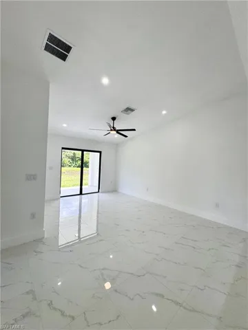 Spare room with light marble finish flooring, recessed lighting, and ceiling fan