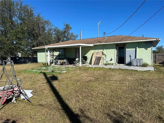 Rear view of house with a lawn