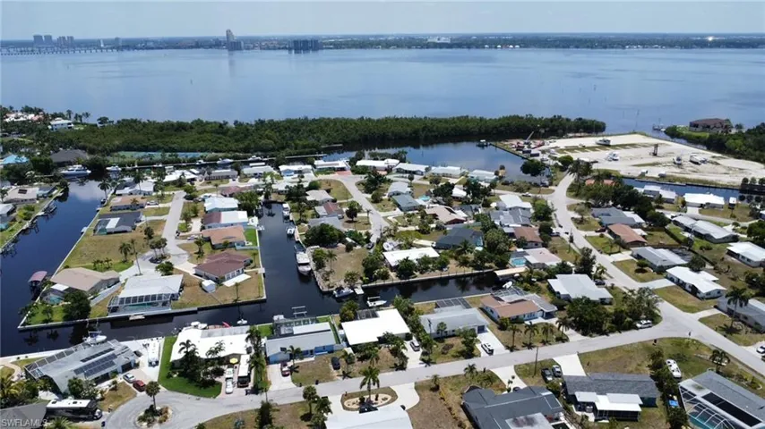 Birds eye view of property with a water view
