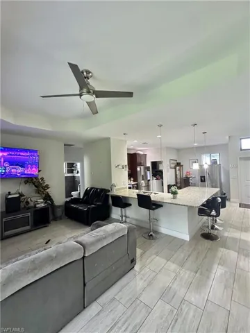 Living room with a ceiling fan and wood finish floors